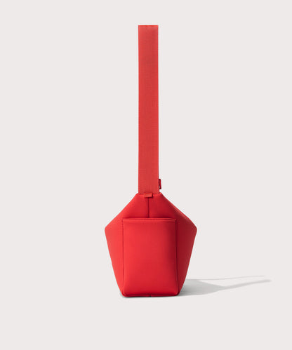 Shoulder bag in a fiery, saturated red leaning toward orange seen from the side view showing phone pocket.