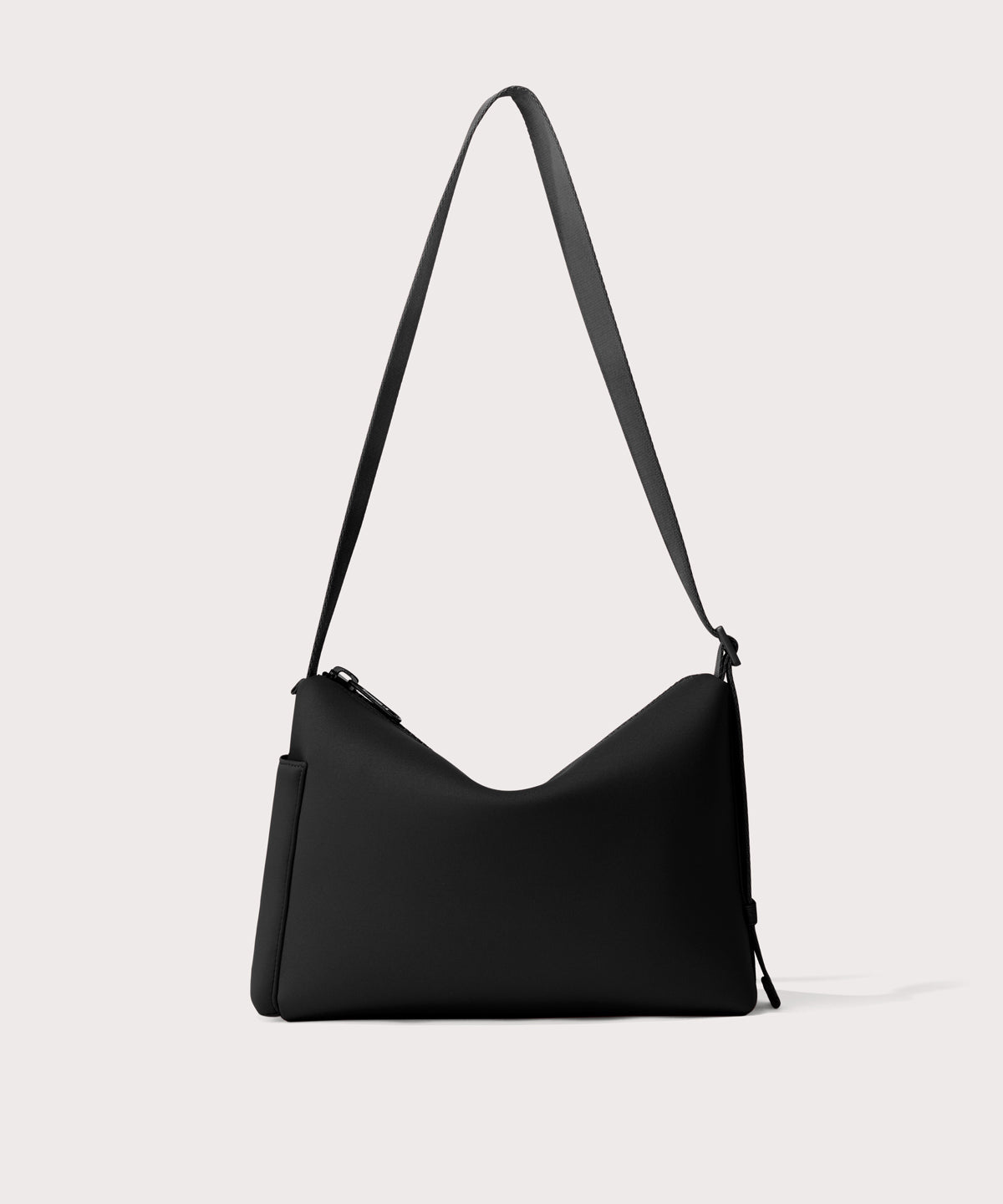 Shoulder bag in a black seen from the back view showing phone pocket.