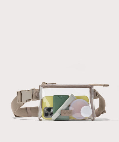Clear crossbody bag with beige strap on a white background with phone and accessories Stadium compliant.
