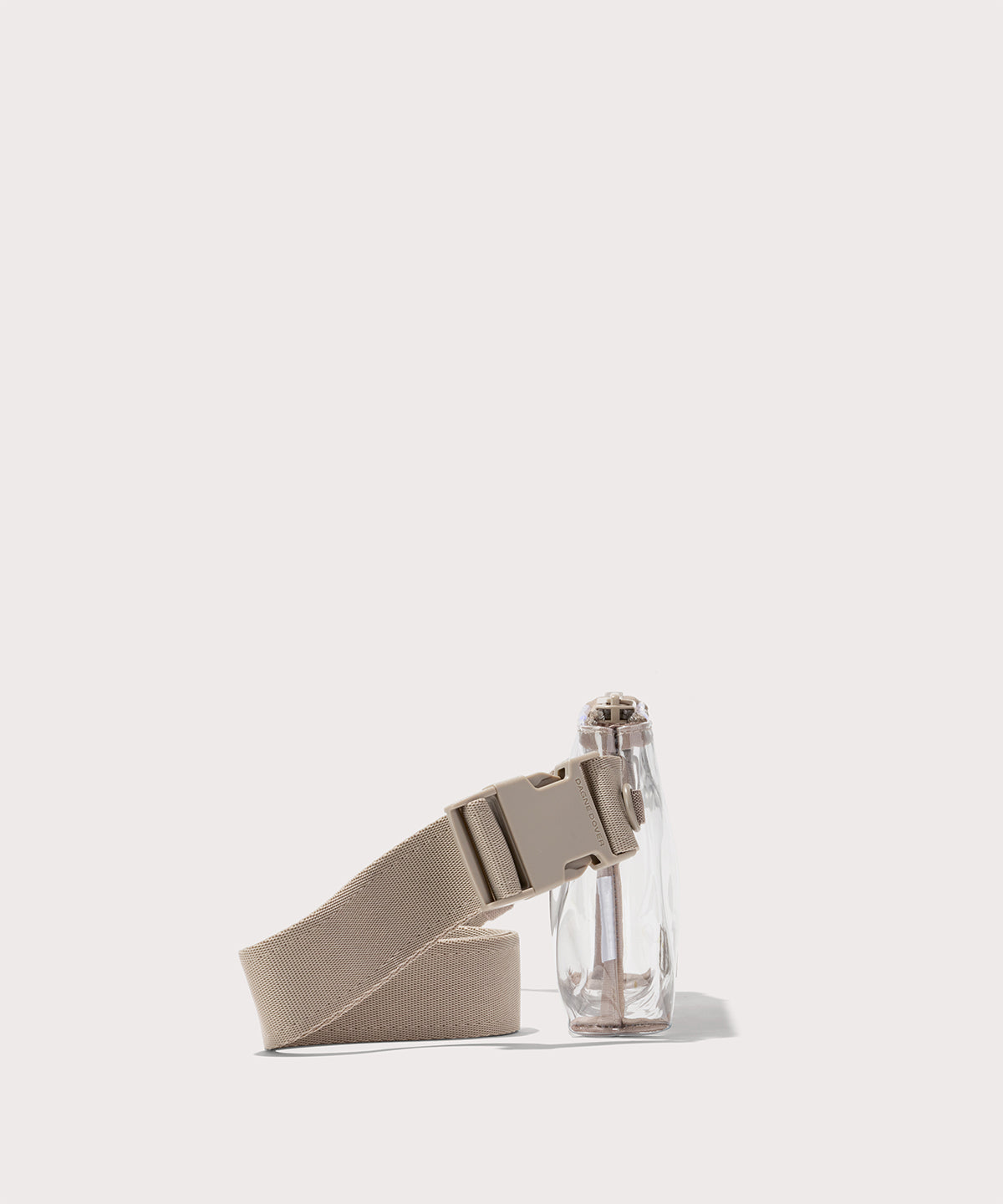 Clear crossbody bag with beige strap on a white background with phone and accessories Stadium compliant.