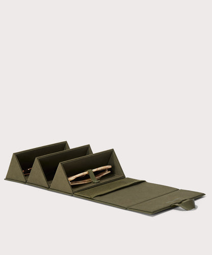Dagne Dover Remi foldable glasses holder in dark green, unfolded and containing sunglasses.