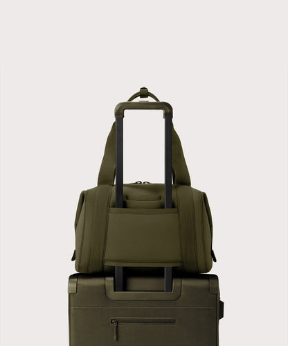 Large Landon Carryall in dark green displaying luggage sleeve