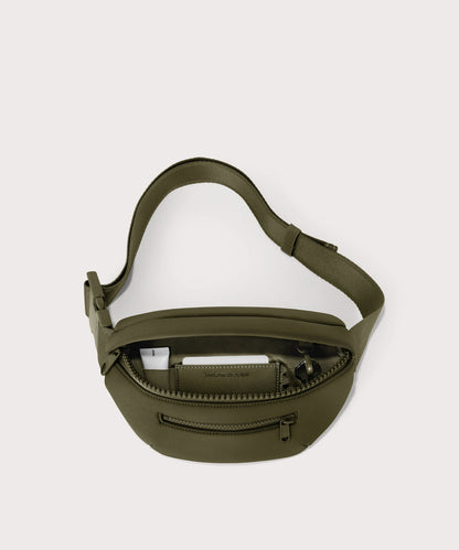 Dagne Dover Ace Fanny Pack in dark green unzipped, exposing the interior pockets
