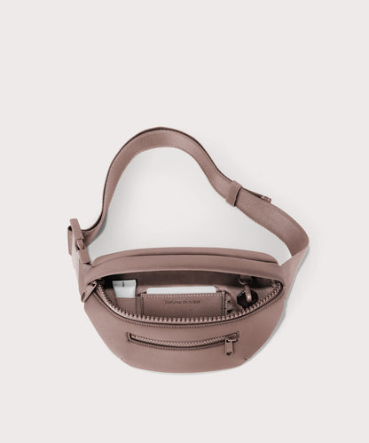 Dagne Dover Ace Fanny Pack in pink unzipped, exposing the interior pockets
