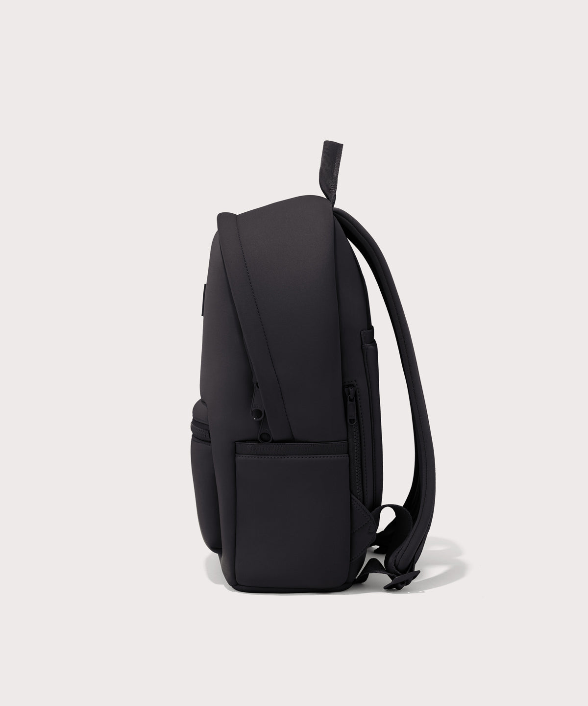 Dagne Dover medium Dakota Neoprene Backpack in onyx seen from the side.