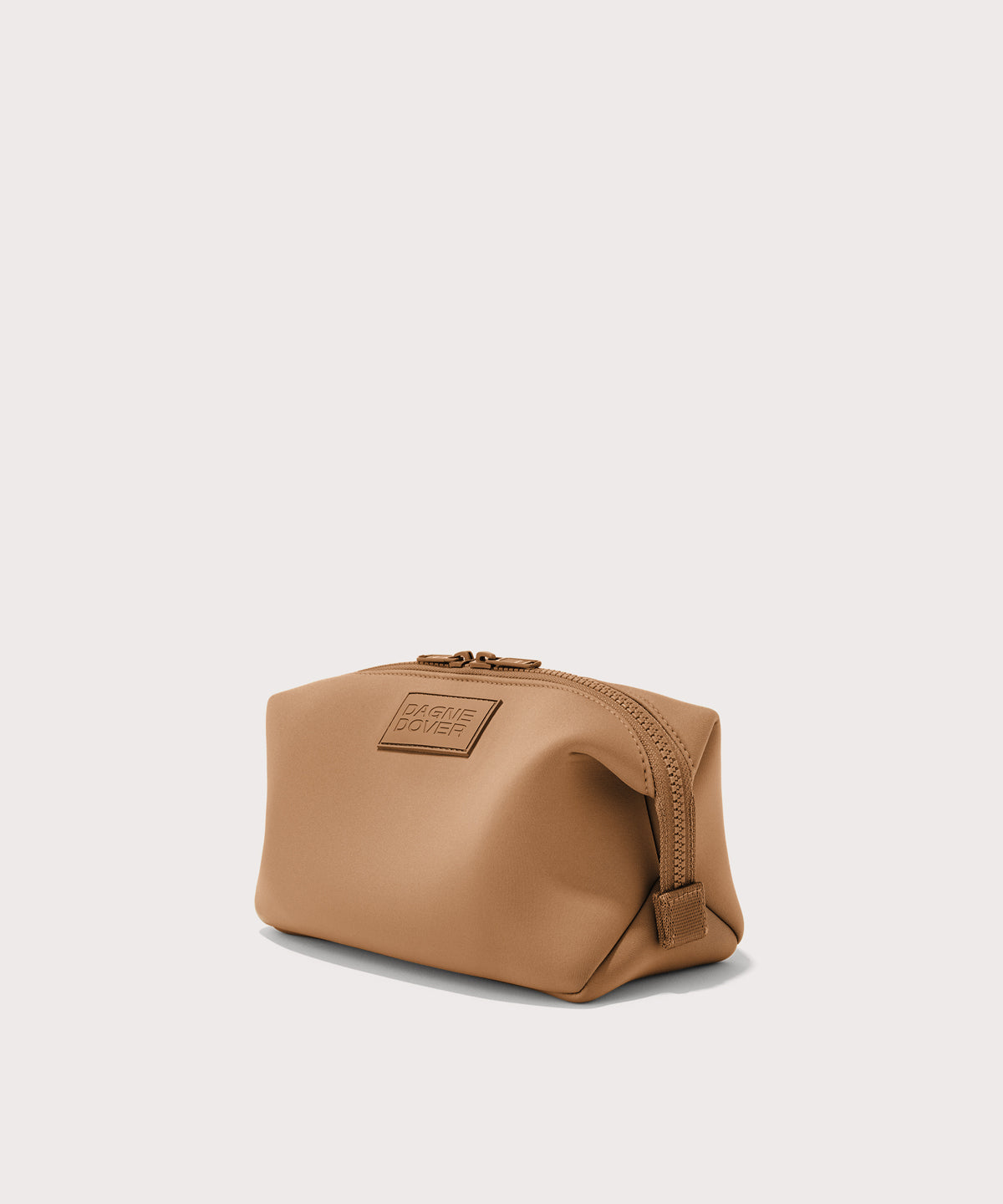Dagne Dover Large Hunter Toiletry Bag in camel brown seen from an angle.