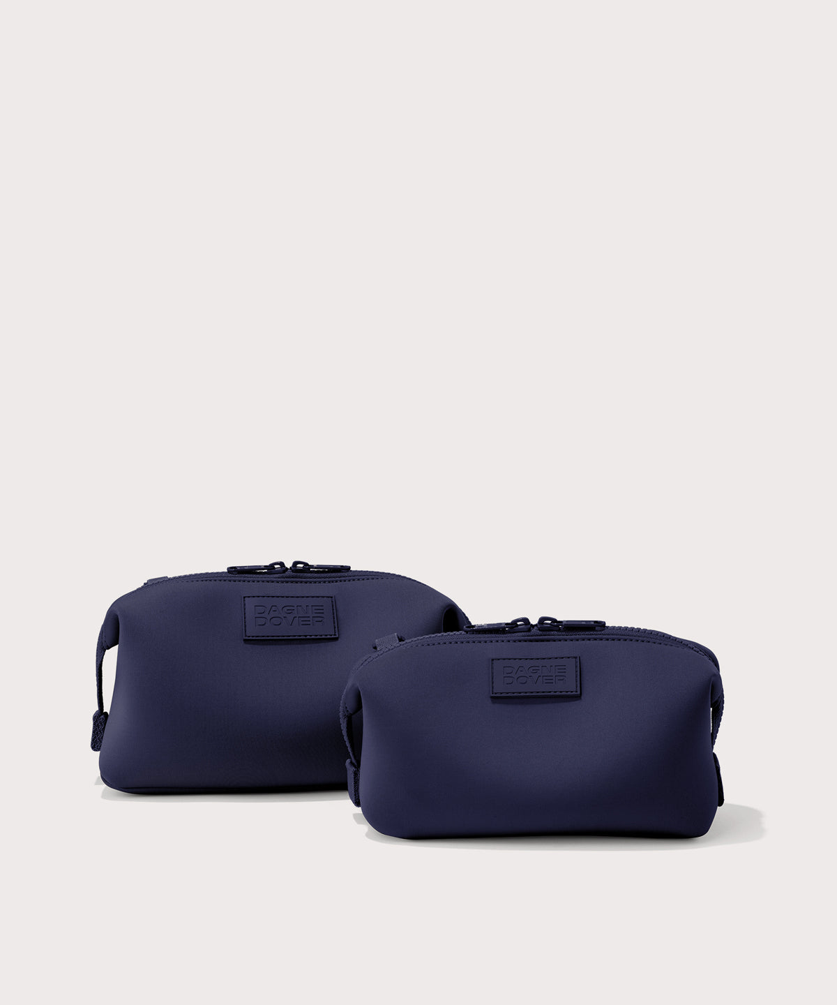 Dagne Dover Small and Large Hunter Toiletry Bags in dark blue.