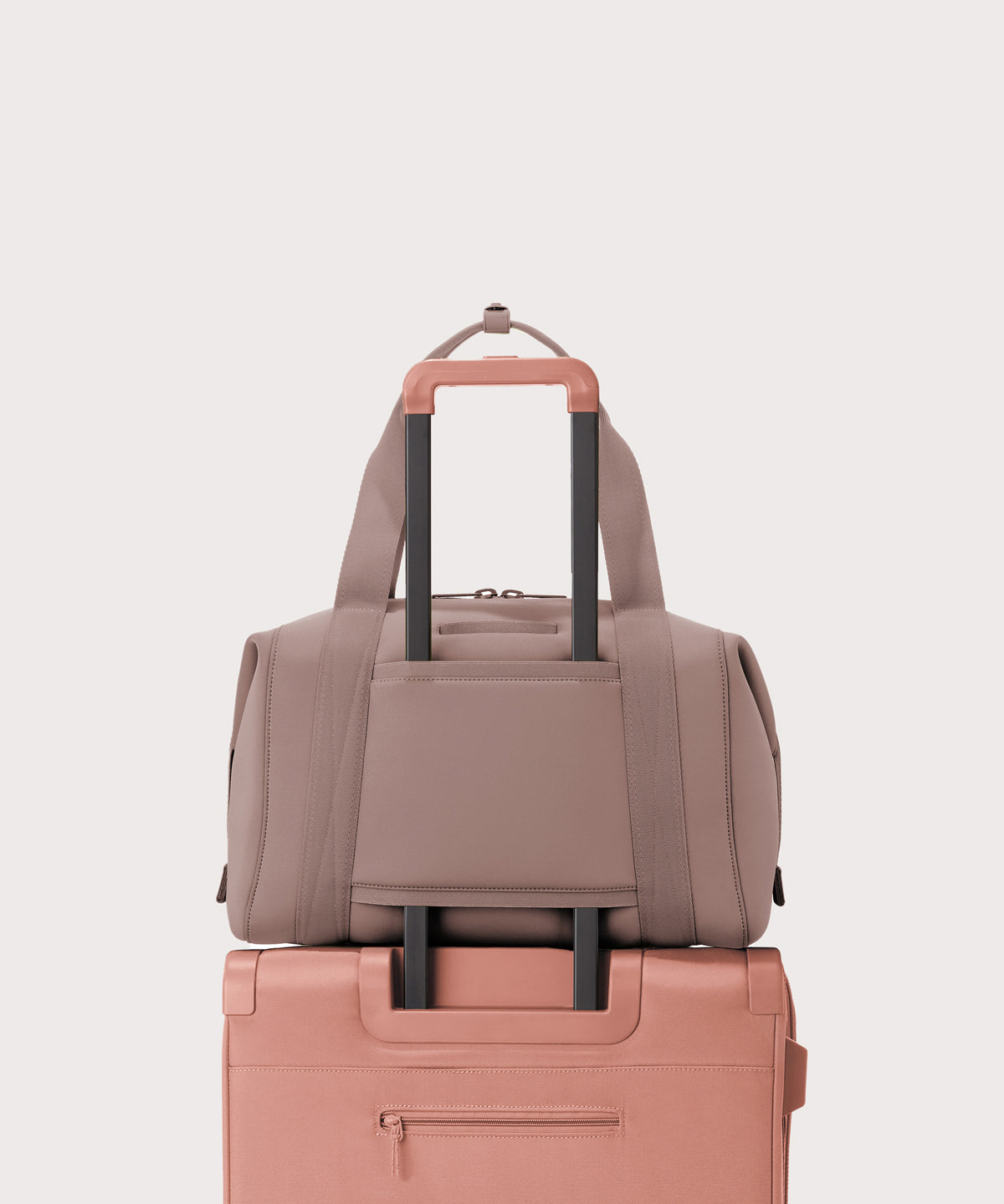 Large Landon Carryall in pink displaying luggage sleeve