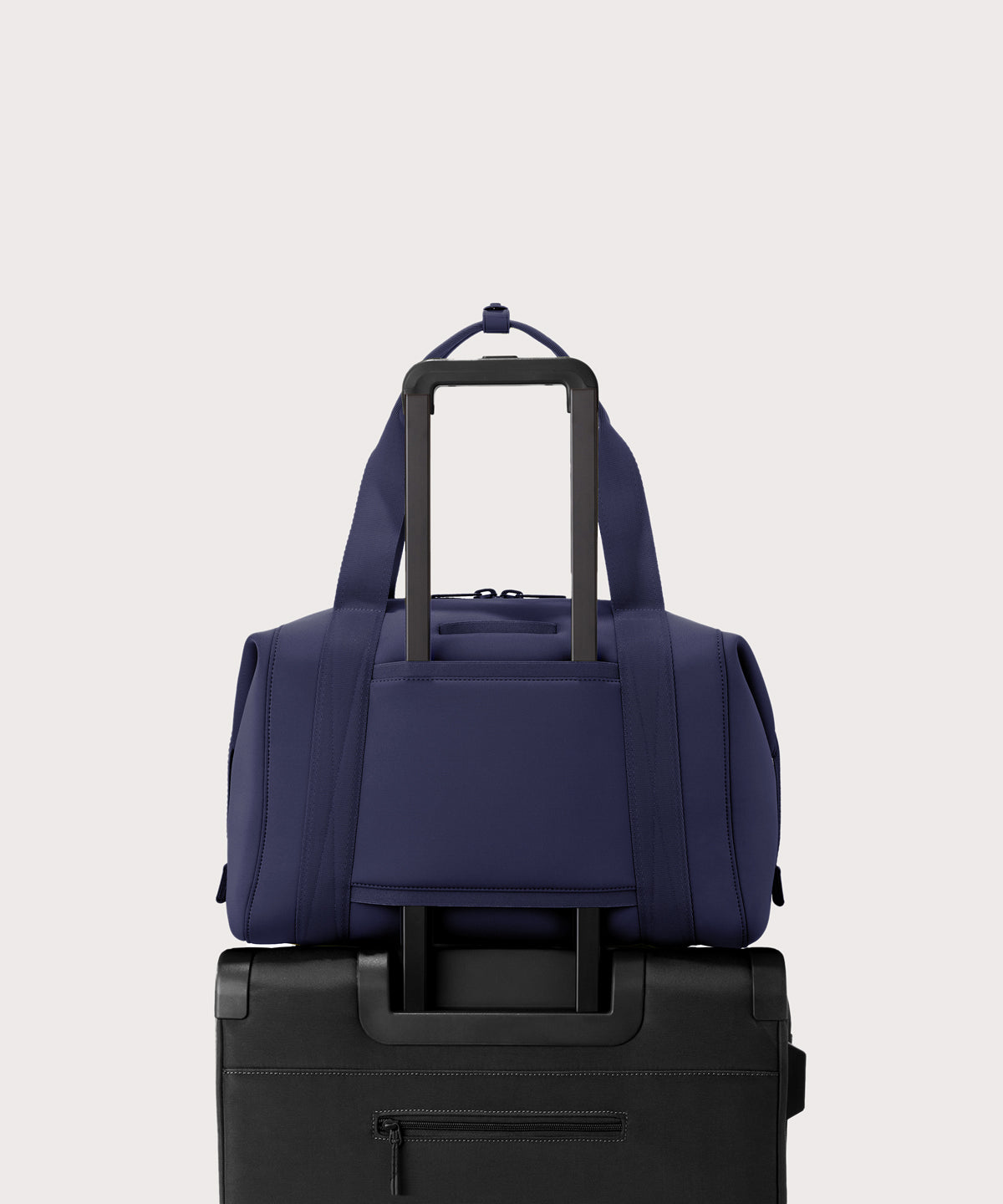 Large Landon Carryall in navy blue displaying luggage sleeve