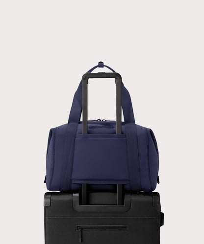 Large Landon Carryall in navy blue displaying luggage sleeve