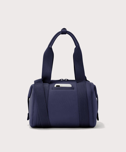 small Landon Carryall in dark blue, displaying an exterior phone pocket