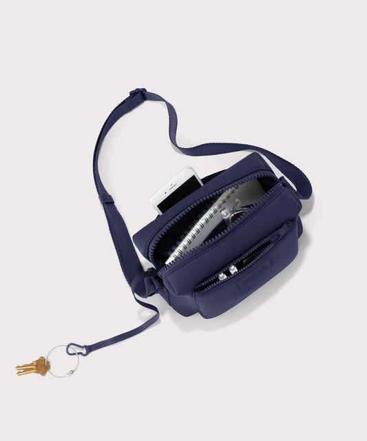 Dagne Dover Micah Crossbody in dark blue seen from above, showing the interior air mesh pocket.