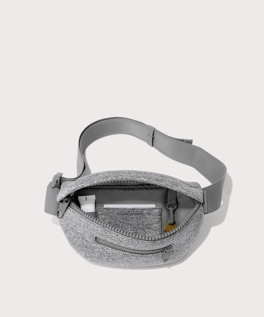 Dagne Dover Ace Fanny Pack in grey unzipped, exposing the interior pockets