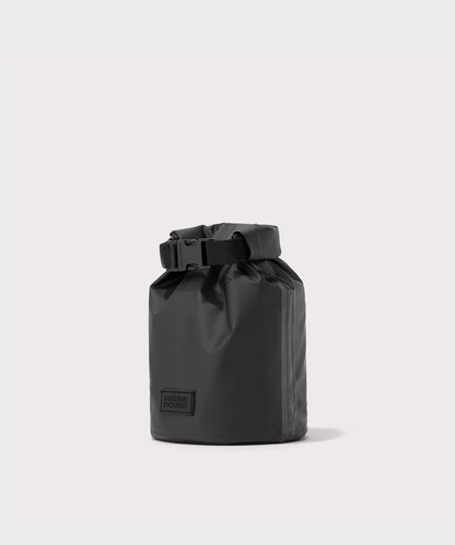 Dagne Dover Rae Roll-Top Dry Bag in black seen from an angle.