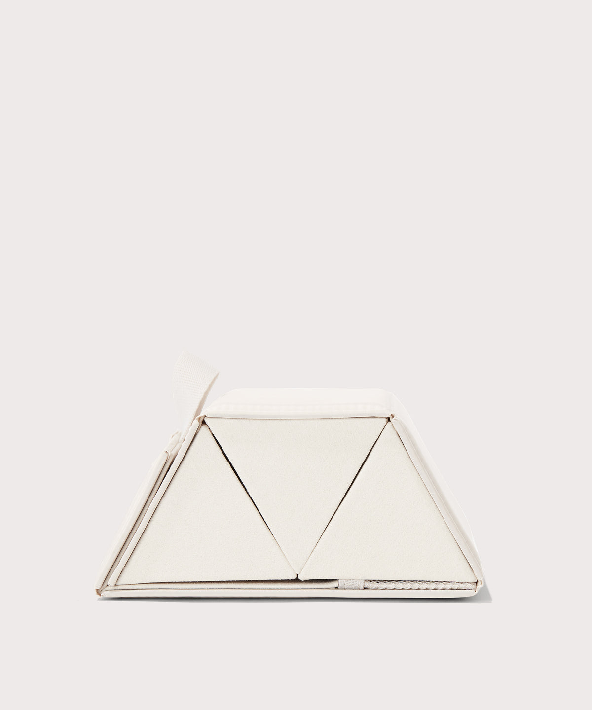 Dagne Dover Remi foldable glasses holder in white seen from the side.