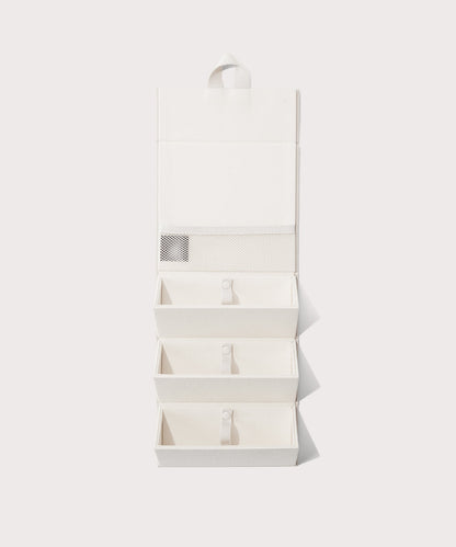 Dagne Dover Remi foldable glasses holder in white hung up.