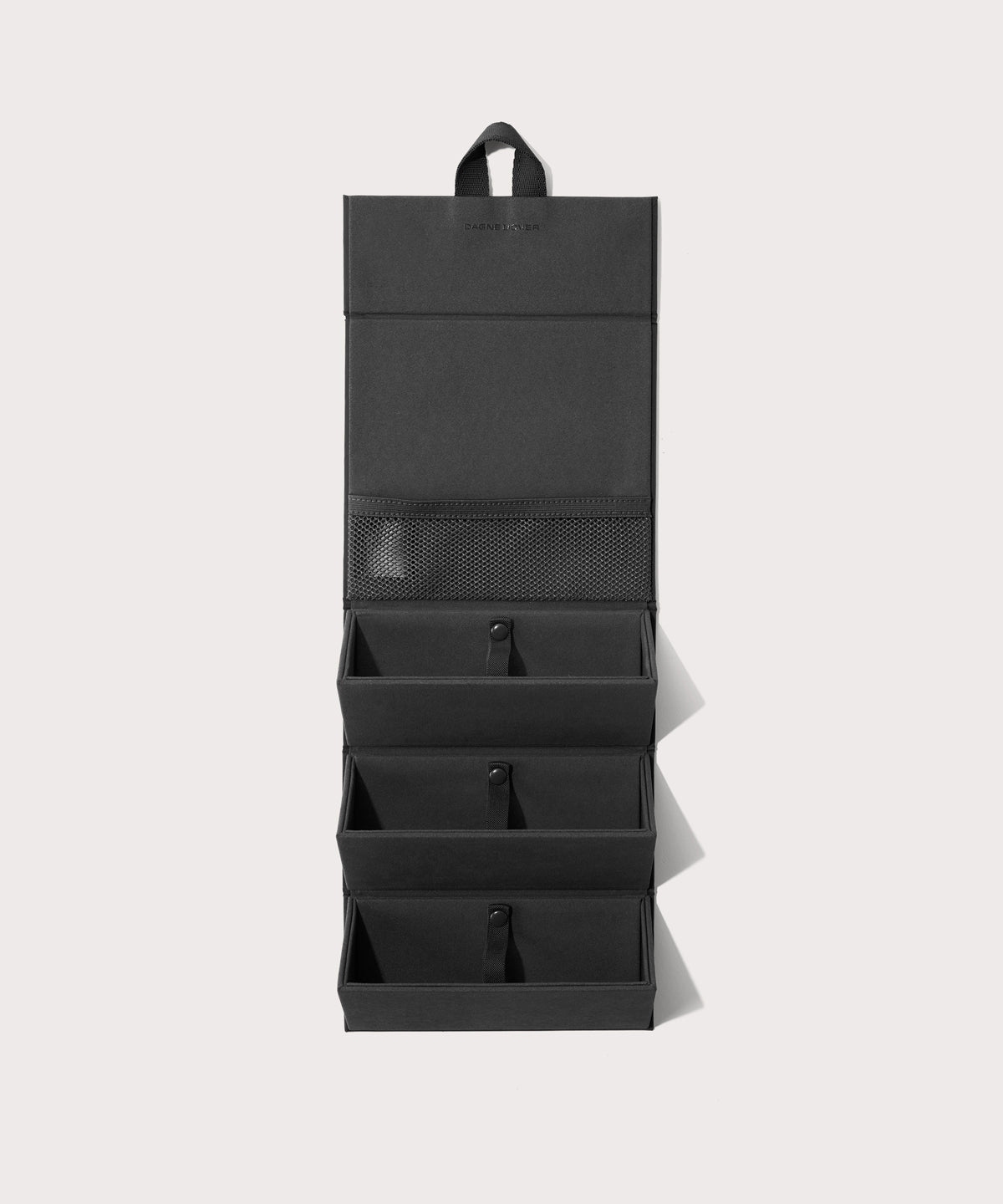 Dagne Dover Remi foldable glasses holder in black hung up.