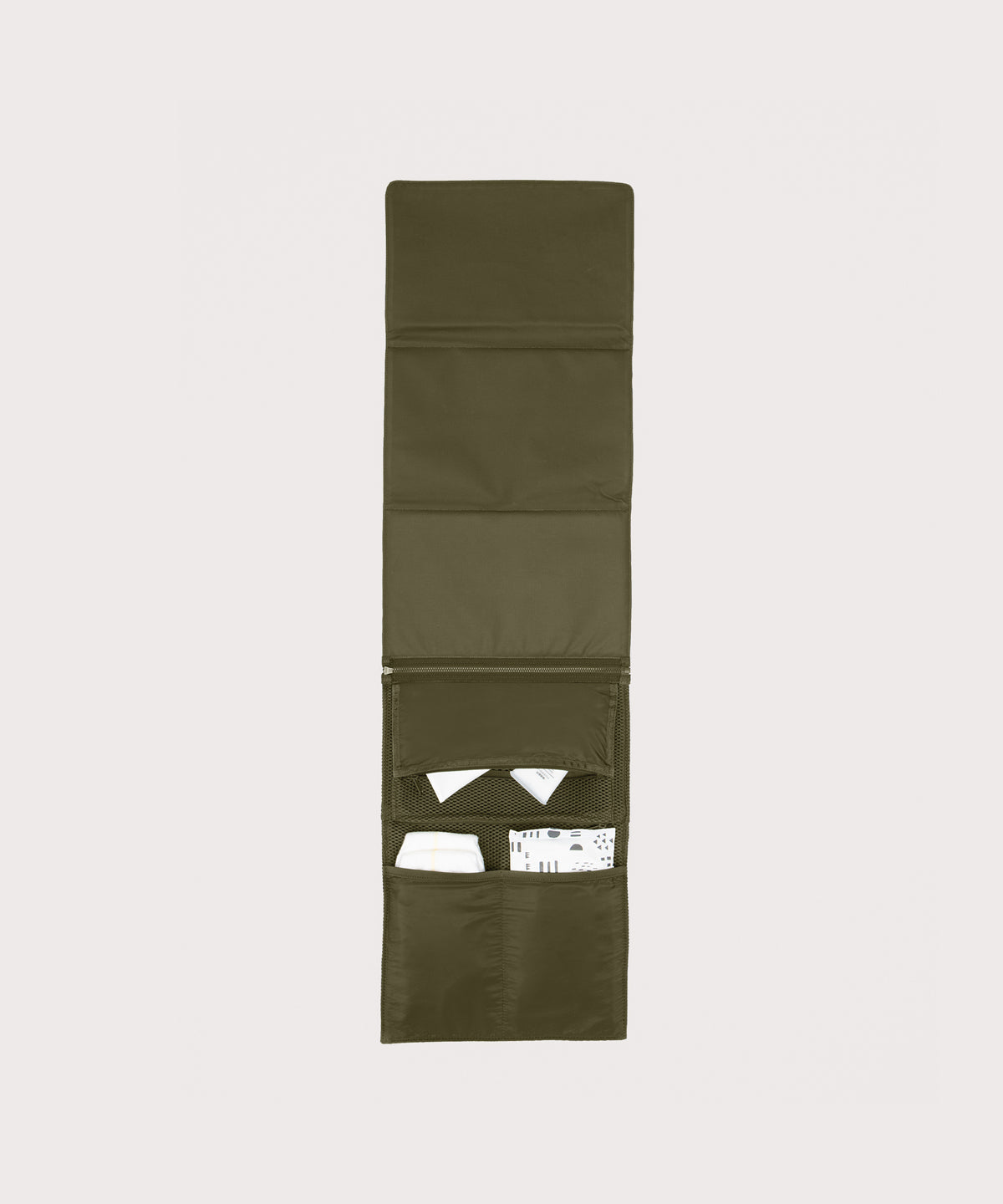 Dagne Dover Joey Changing Kit in dark moss unfolded, revealing the interior zipper pocket and interior slip pockets.