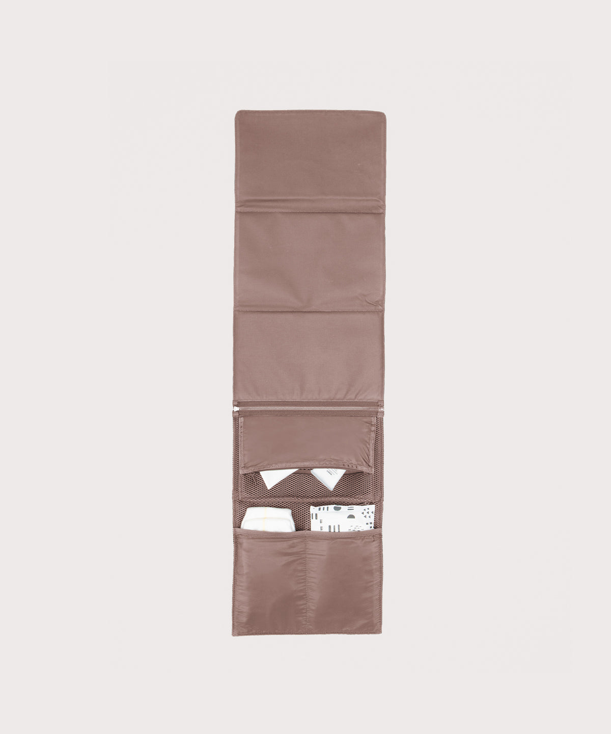 Dagne Dover Joey Changing Kit in pink unfolded, revealing the interior zipper pocket and interior slip pockets.