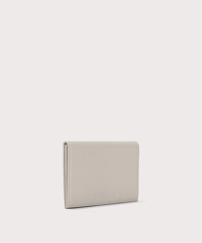 Dagne Dover Accordion Travel Wallet in white seen from an angle.