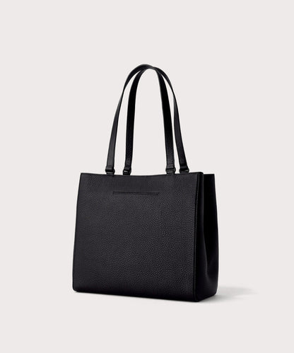Dagne Dover medium Allyn Tote in black with the exterior slip pocket.