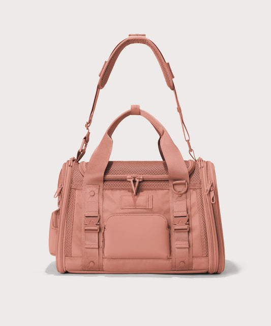 Dagne Dover small Kyoto Pet Carrier in a warm dust pink seen from the front with crossbody strap.