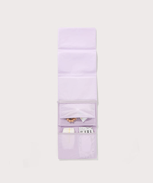 Dagne Dover Joey Changing Kit in a soft purple with grey undertones unfolded, revealing the interior zipper pocket and interior slip pockets.