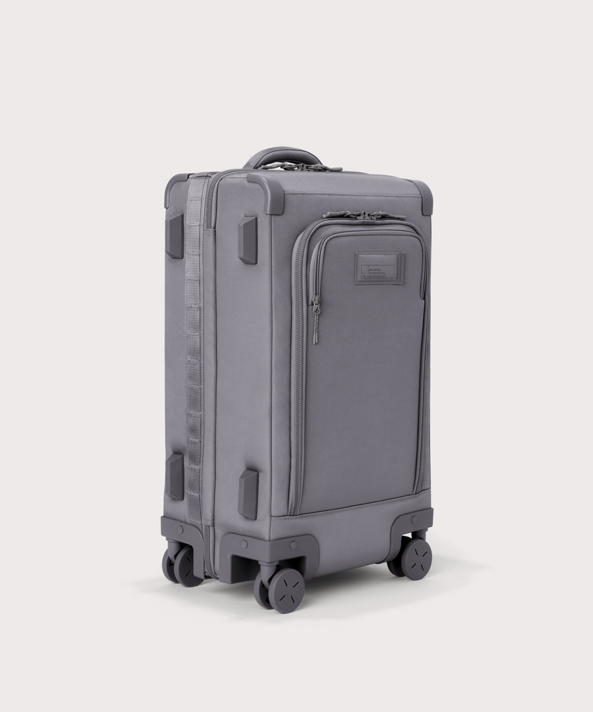 ¾ front view of Seattle carry-on rolling luggage 23.5” in light grey with front flap opened. Caption: Interior slip pocket fits most 16" laptops