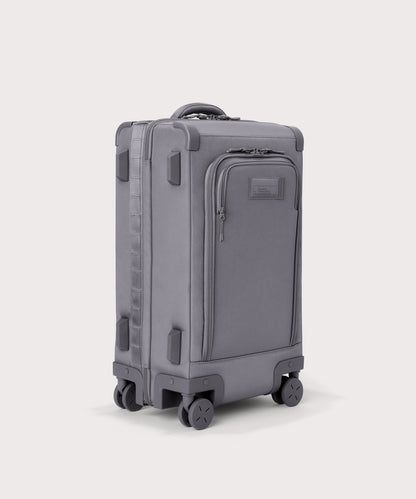¾ front view of Seattle carry-on rolling luggage 23.5” in light grey with front flap opened. Caption: Interior slip pocket fits most 16" laptops