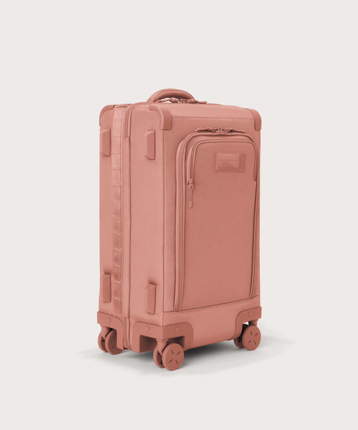 ¾ front view of Seattle carry-on rolling luggage 23.5” in warm dust pink with front flap opened. Caption: Interior slip pocket fits most 16" laptops