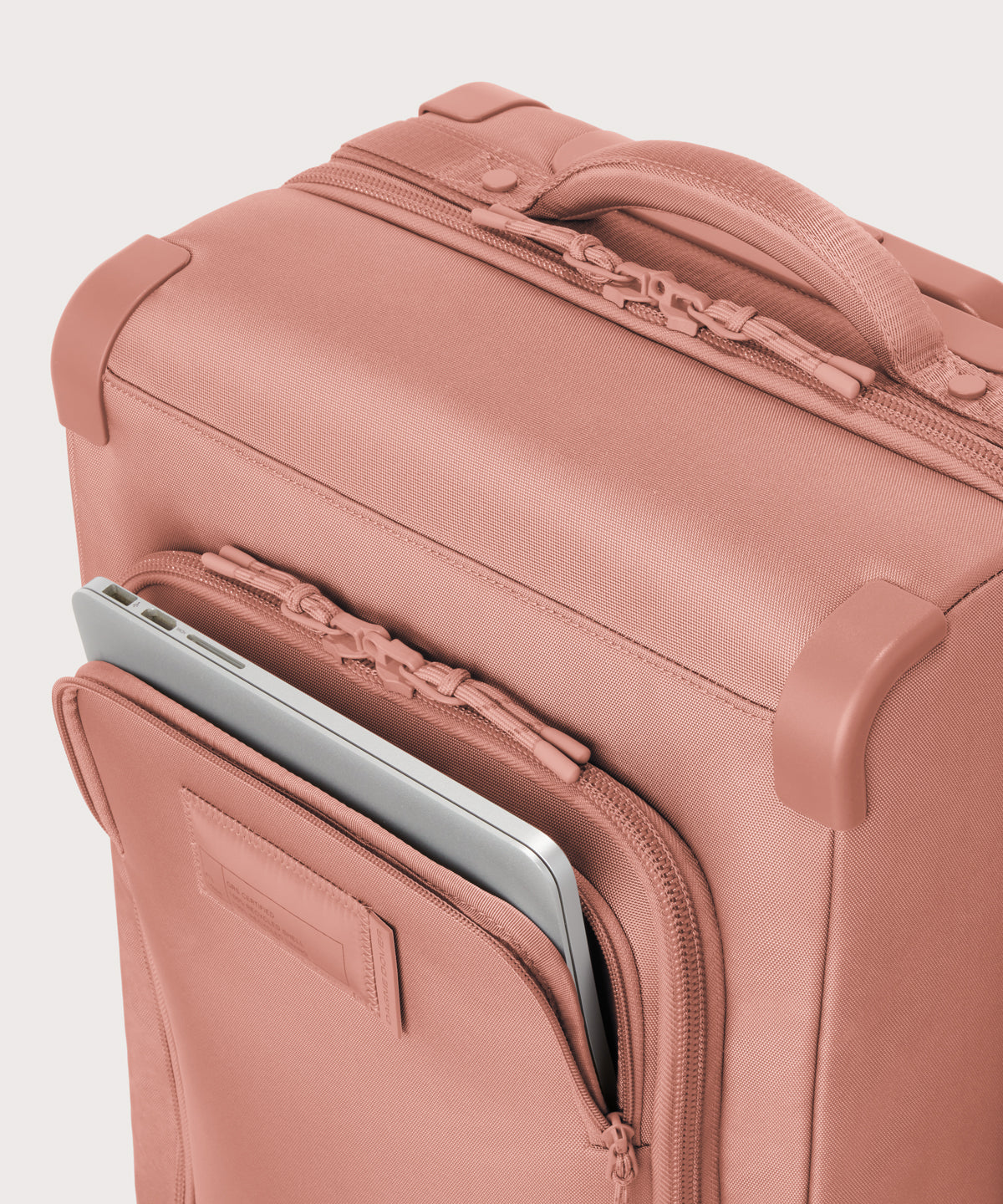 Caption: Front pocket fits most 13” laptops