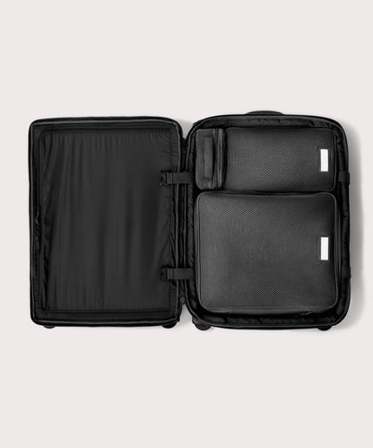Top down of Sydney checked rolling luggage 25" in black with interior divider zipped and packing cubes packed into the right side.